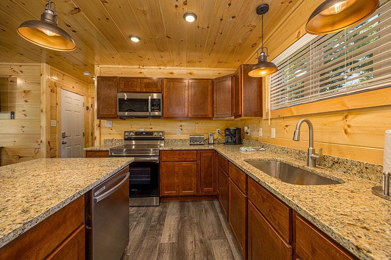 Enjoy snacks to holiday meals in your cabin's fully equipped kitchen. at Big Splash Lodge in Gatlinburg TN