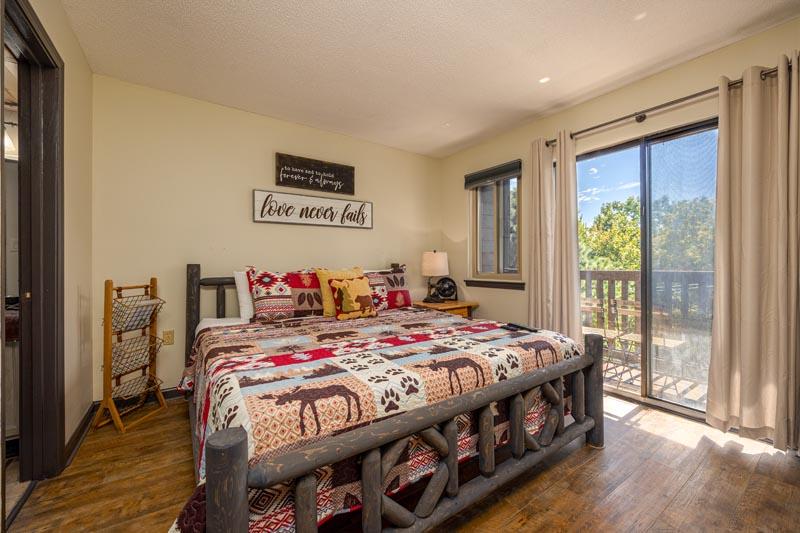 Gatlinburg condo bedroom with sliding glass doors onto the balcony. at A Moonlit Kiss in Gatlinburg TN