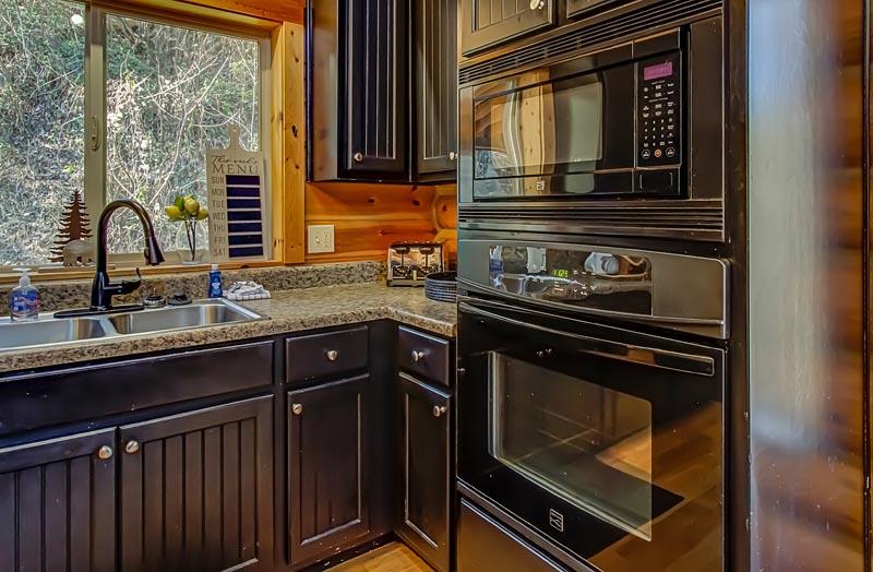 Prepare holiday meals to snacks in your log cabin rental's fully equipped kitchen. at A Great Escape in Gatlinburg TN