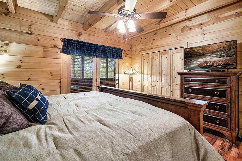 Bedroom with television and walk out onto porch. at Alpine Oasis in Gatlinburg TN