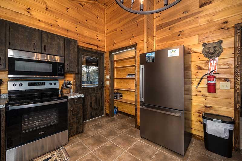 Stainless steel stove and fridge at your cabin in the Smokies. at Moonlight Obsession in Gatlinburg TN