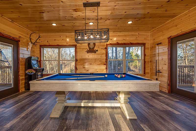 Cabin game room with pool table, multi-game arcade and big screen tv. at Morning View in Gatlinburg TN