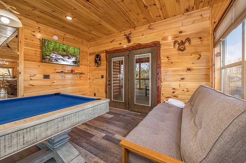 Game room with flat screen tv and futon seating. at Sunset Peak in Gatlinburg TN