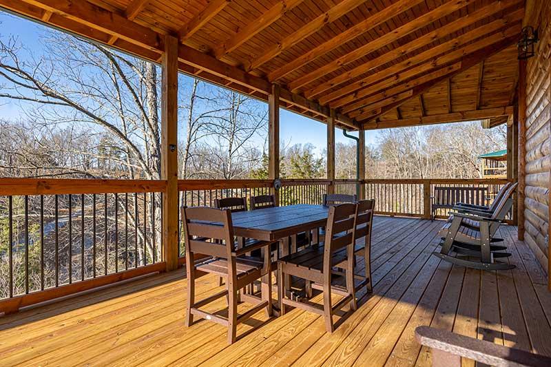 Enjoy eating outdoors on your cabin's porch table. at Sunset Peak in Gatlinburg TN