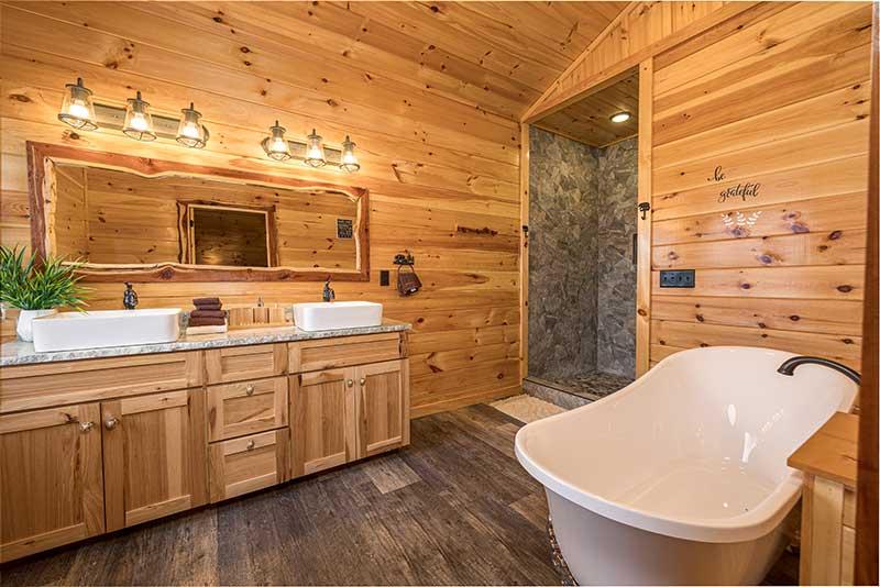 Your rental cabin's master bath with clawfoot bathtub. at Sunset Peak in Gatlinburg TN