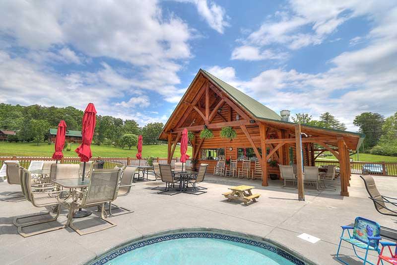 Seating area next to the kiddie pool at Honey Suckle Meadows RV Park in Wears Valley Tennessee. at Alpine Oasis in Gatlinburg TN