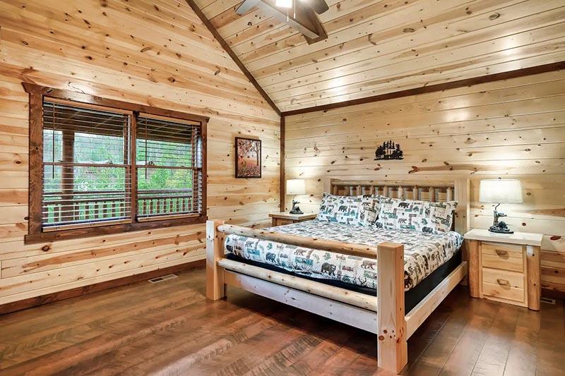 Sleep comfortable in your own king sized log bed. at Cabin Fever Vacation in Gatlinburg TN