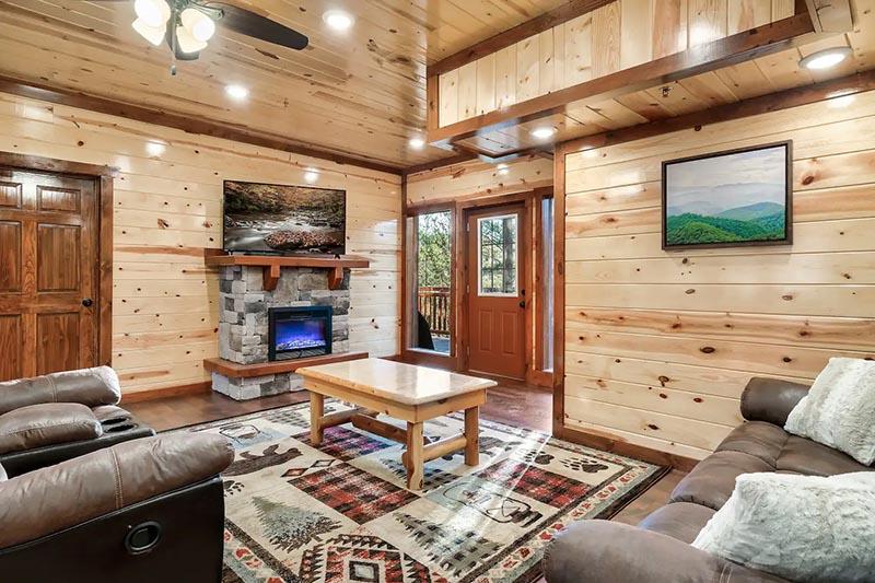 Living room of your 8 bedroom Smoky Mountains cabin rental. at Cabin Fever Vacation in Gatlinburg TN