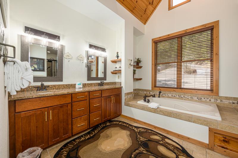 Nice bath with double sinks and Jacuzzi bath. at Five Bears Mountain View Lodge in Gatlinburg TN