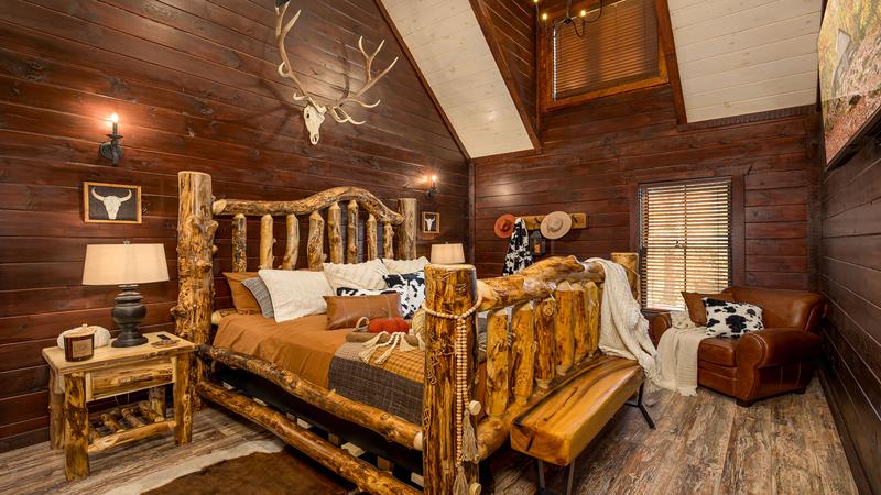 Cabin's king sized log bed. at Stonehenge Cabin in Gatlinburg TN