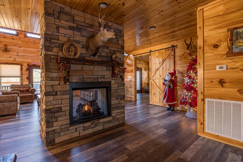 Warm glow from the cabin's double sided fireplace. at Sunset Peak in Gatlinburg TN