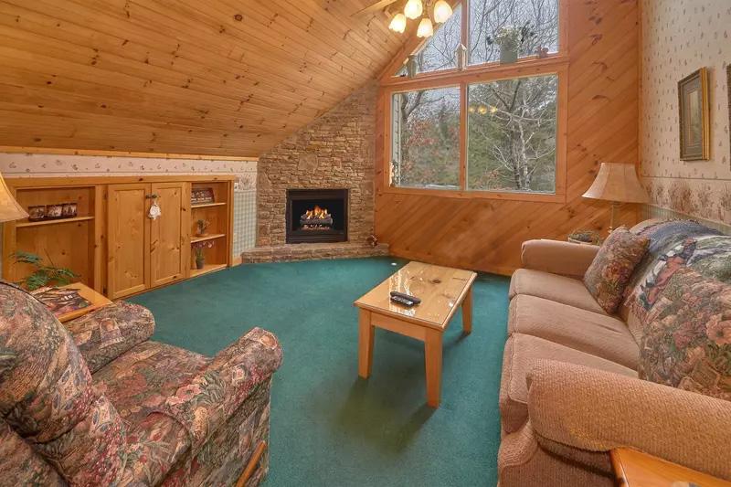 Cabin's upstairs seating with fireplace. at Wrap Around The Son in Gatlinburg TN