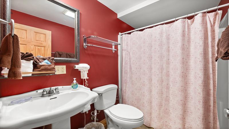 Tub shower combo in your cabin's second og three full baths. at Moonlight Pines Lodge in Gatlinburg TN