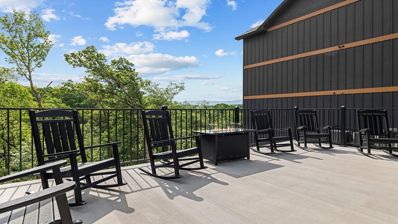 Your cabin's very large deck affords lots of seating around the gas fire pit as well as room to tan. at Royce' s Retreat in Gatlinburg TN