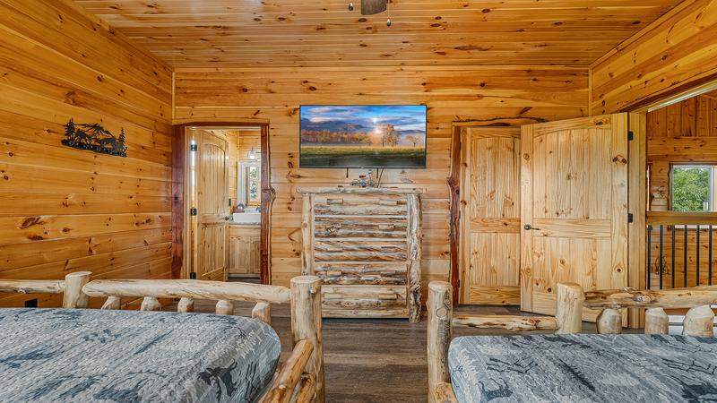 Log queen beds 3rd bedroom with TV.