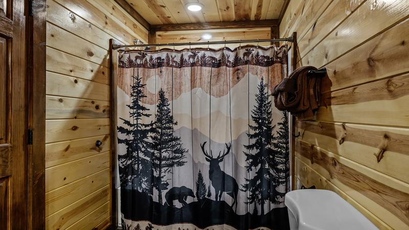Bathtub and shower in your cabin's third of eight baths.