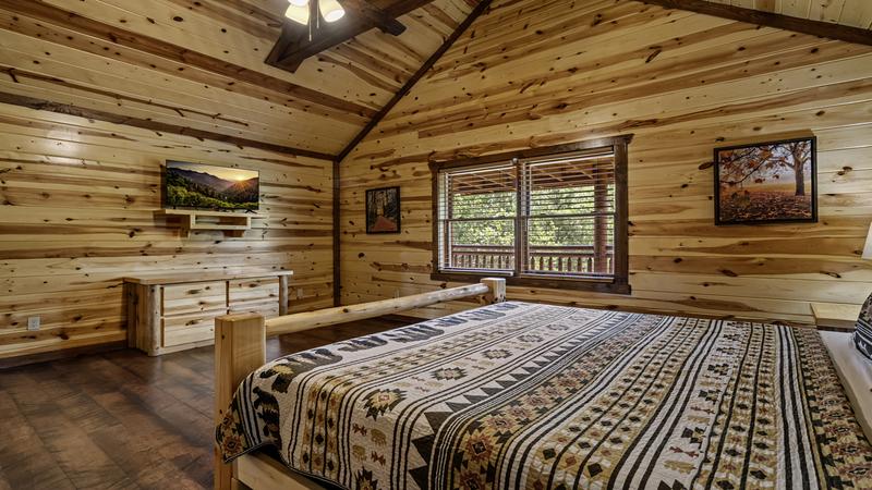 Cabin's sixth bedroom with television.