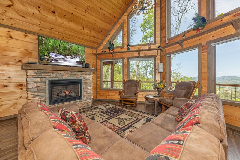 The Appalachian, a Pigeon Forge rental cabin with fireplace and large wall of windows. at The Appalachian in Gatlinburg TN