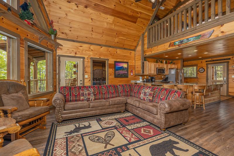 Cabin's living room seating towards the open kitchen. at The Appalachian in Gatlinburg TN