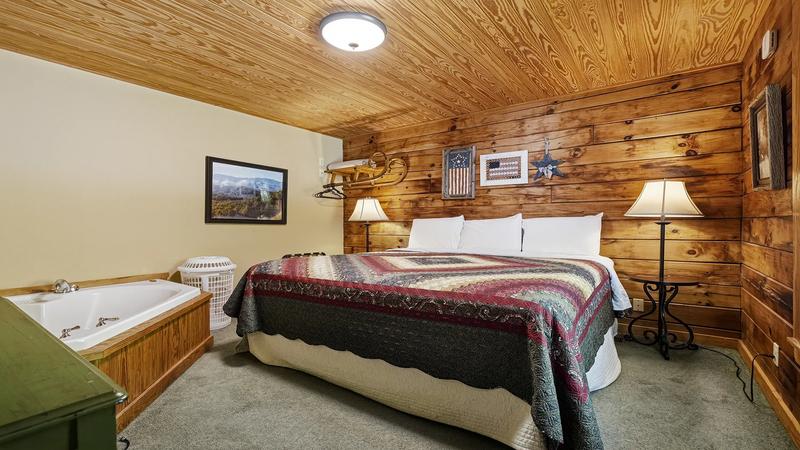 Cabin Rental Bedroom With Jacuzzi Cabin bedroom with Jacuzzi tub.