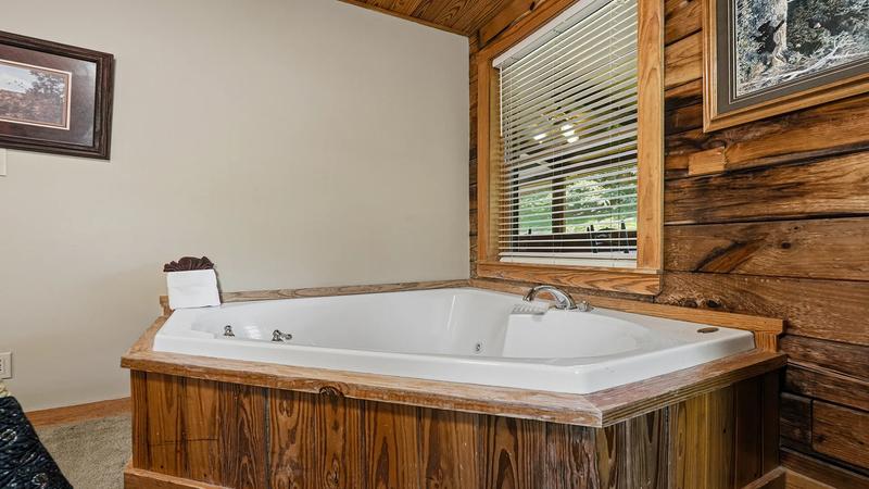 Second Bedroom With Jacuzzi Tub Cabin rental's second bedroom with Jacuzzi tub.