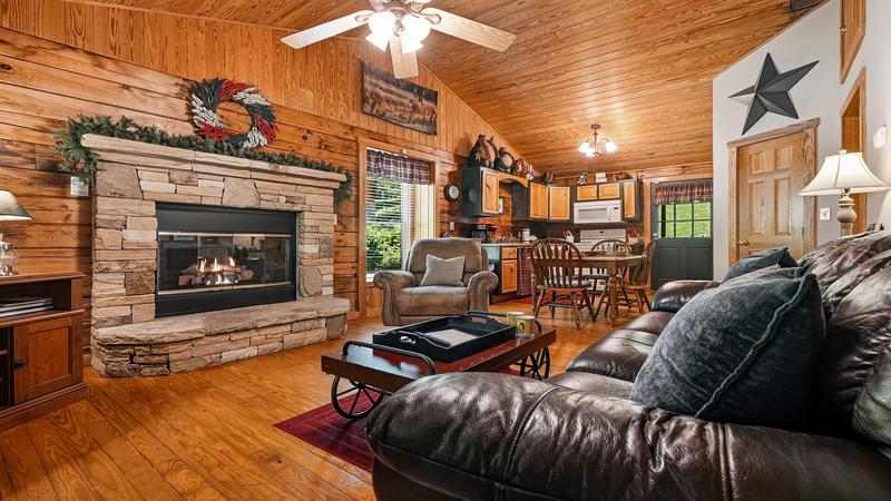 Cabin Rental Stacked Stone Fireplace Stacked stone gas log fireplace and plush leather couch.