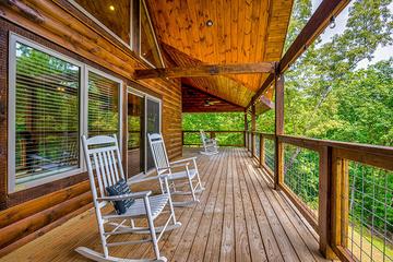 Enjoy your large cabin porch in a wooded setting.   at Big Splash Lodge in Gatlinburg TN