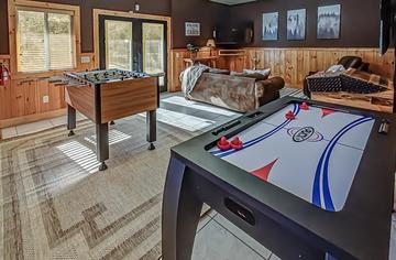 Cabin rental game room with foosball, air hockey and arcade machine. at A Great Escape in Gatlinburg TN