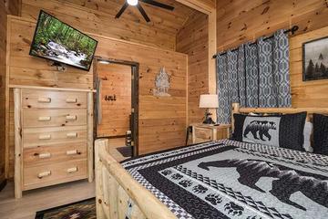 Cabin bedroom with tv and full private bath. at Moonlight Obsession in Gatlinburg TN