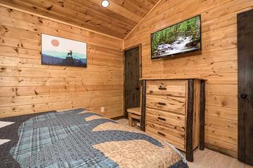 Enjoy late night tv relaxing in your cabin's bedroom. at Moonlight Obsession in Gatlinburg TN