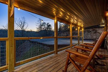 Smokies cabin with lighted covered porch. at Moonlight Obsession in Gatlinburg TN