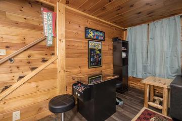 Your cabin rental features a multi-player arcade. at Moonlight Obsession in Gatlinburg TN