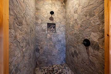 Cabin bath with stone wall shower. at Morning View in Gatlinburg TN