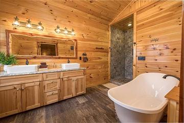 Your rental cabin's master bath with clawfoot bathtub. at Sunset Peak in Gatlinburg TN