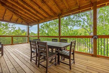 Outside dining table on your cabin's porch. at Sunset Peak in Gatlinburg TN