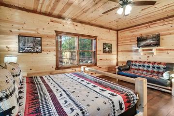 First bedroom's television and extra seating area. at Cabin Fever Vacation in Gatlinburg TN