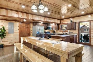 Large farm style dining table at your cabin in the Smokies. at Cabin Fever Vacation in Gatlinburg TN