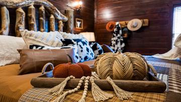 King sized log bed in artistic cabin photo. at Stonehenge Cabin in Gatlinburg TN