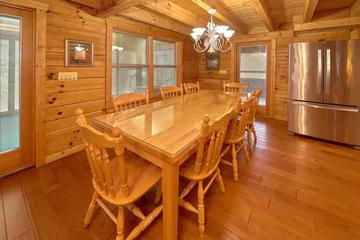 Enjoy holiday meals at your cabin's large dining table. at Wrap Around The Son in Gatlinburg TN