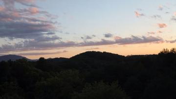 Take in the splendor of sunsets over the Smoky Mountains from your cabin porches. at Moonlight Pines Lodge in Gatlinburg TN