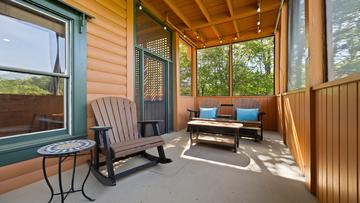 Plenty of seating in the screened in porch for taking in natures sounds. at Moonlight Pines Lodge in Gatlinburg TN