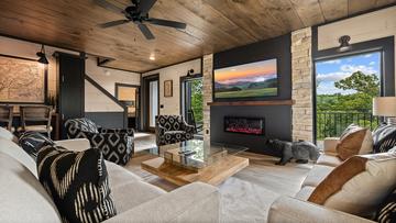 The whole family can relax around the beautiful fireplace while watching the big screen tv. at Royce' s Retreat in Gatlinburg TN