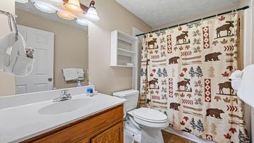 Your Smokies cabin's third full bath with shower and tub combo. at Bear Crossing in Gatlinburg TN