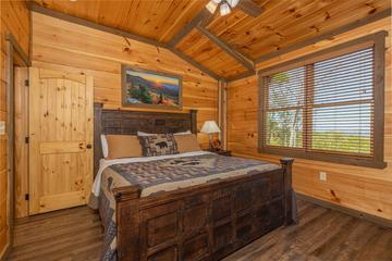 Cabin rental upstairs bedroom with large relaxing bed. at The Appalachian in Gatlinburg TN