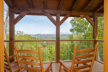 Relax outdoors with the Smoky Mountains in these relaxing rockers under the cabin's porch. at The Appalachian in Gatlinburg TN