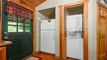 Cabin Fridge Washer And Dryer Cabin rental's stacked washer-dryer and full sized fridge.